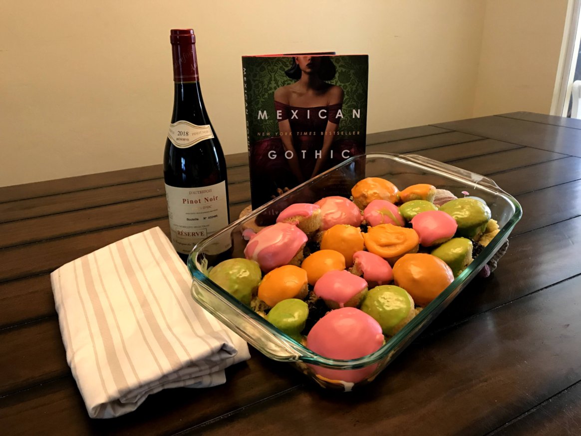 Mexican Gothic novel with wine and cupcakes